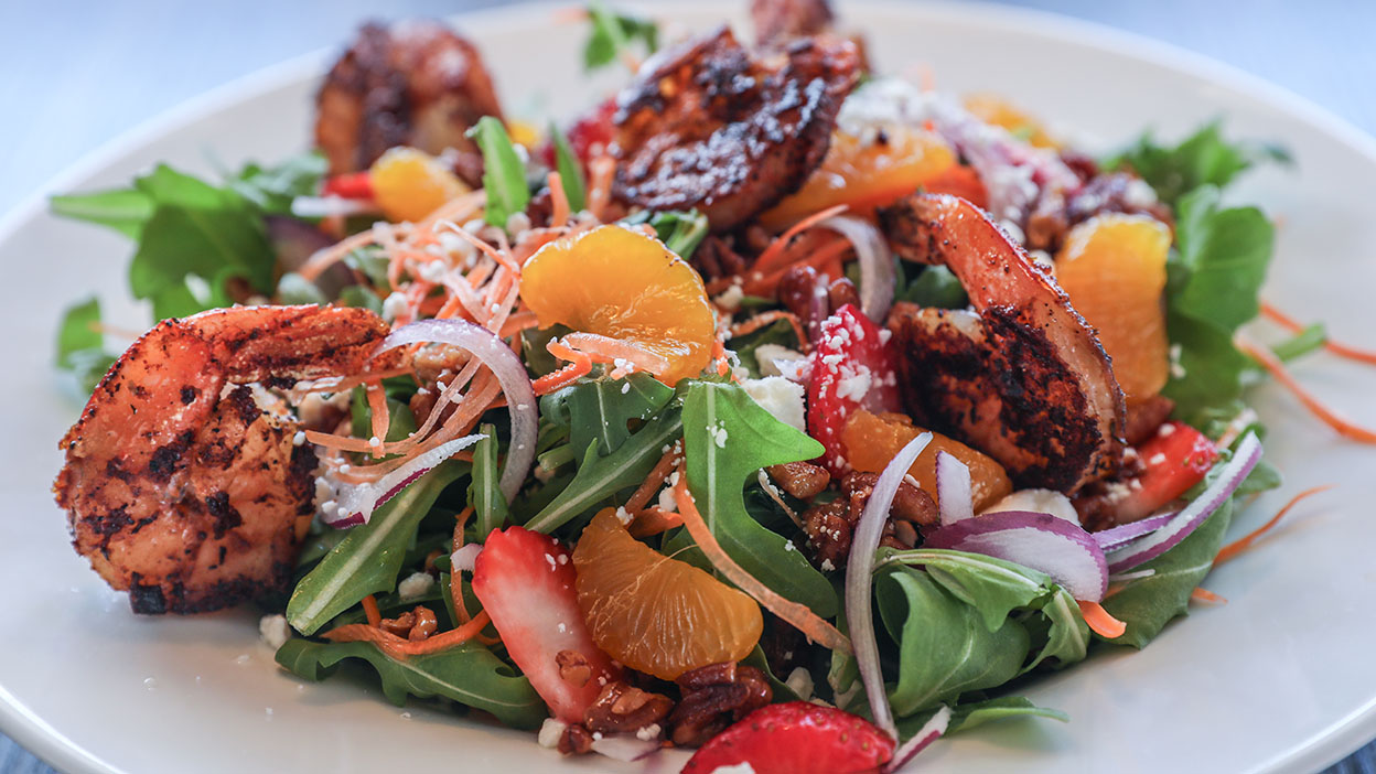 Cajun grilled shrimp over arugula, strawberries, mandarin oranges, goat cheese, candied pecans, thinly-sliced carrots and red onions